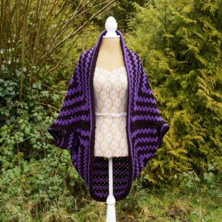 My Bean Sidhe Hug Shrug cardigan. 👻

It is a handmade crocheted cardigan featuring bold shades of purple and black (my favourite colours). 

The Bean Sidhe is a prominent figure in Irish folklore. The dark shades of black and purple symbolise her mournful cries and ghostly appearance as well as the mystical elements of Irish mythology and folkore.

The cardigan is made with a blend of chunky stitches and is edged with a boarder on the main body and sleeves. The edging on the main body has a slight outward curve.

It can be styled a number of ways as a jumper can fit under the sleeves for chillier days and it can easily be worn in warmer weather too. 

The cardigan is designed to be an oversized fit and has a boho feel to it. Whatever way you choose to style my Bean Sidhe cardigan, it will feel like a hug.

#handmadeinireland #irishdesign #irishcrafts #irishfolklore #cosystyle